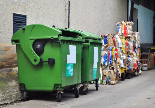 Workers assessing a cluttered room before rubbish removal